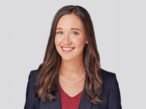 Headshot of Kristin Nalbach, attorney at Fraser Stryker in Omaha, NE, wearing a dark blue suit jacket and red shirt.