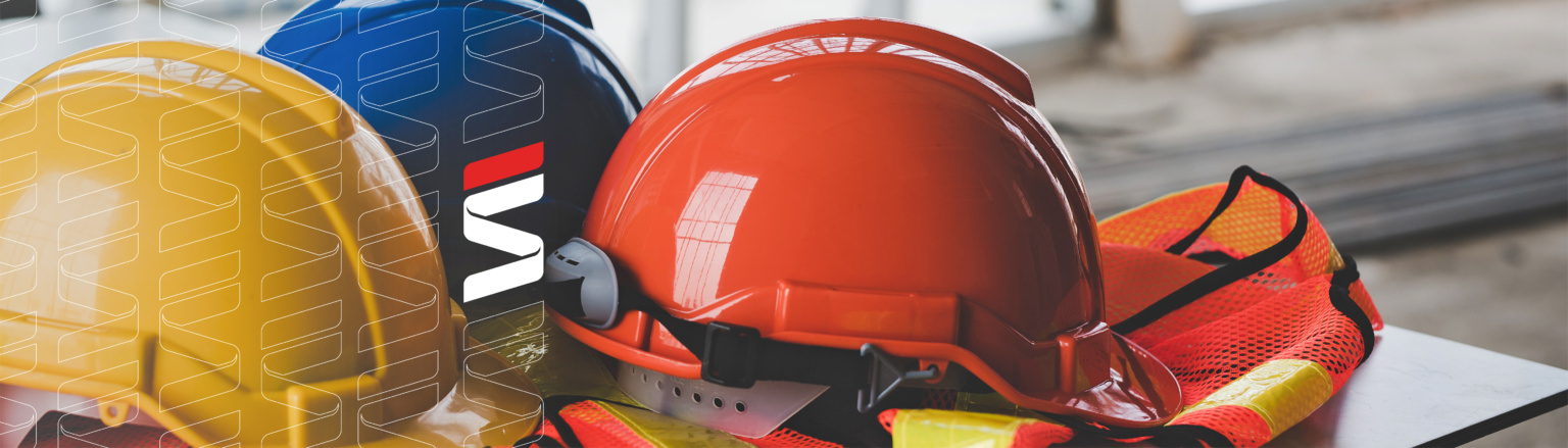 Yellow, blue, and orange hard hats with safety vests on table. Fraser Stryker Icon on left side of image.
