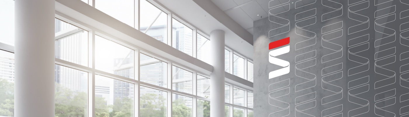 Modern interior design featuring floor-to-ceiling windows, clean lines, and a sleek wall display. Fraser Stryker logo repeating on right side.