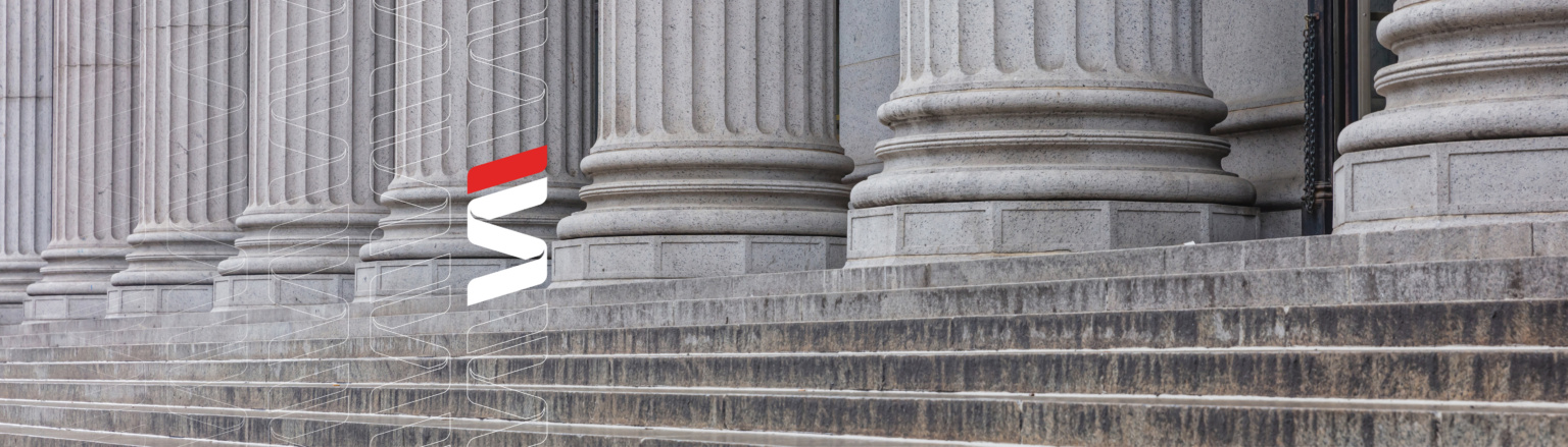 Close-up view of classical stone columns with intricate fluting details, standing on a set of wide stone steps. Fraser Stryker logo pattern on the left side.