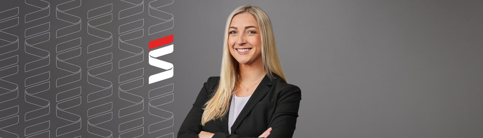 Photo of Heidi Strigenz, wearing a white shirt and a black jacket. Fraser Stryker logo icon repeating on the left side of the photo.