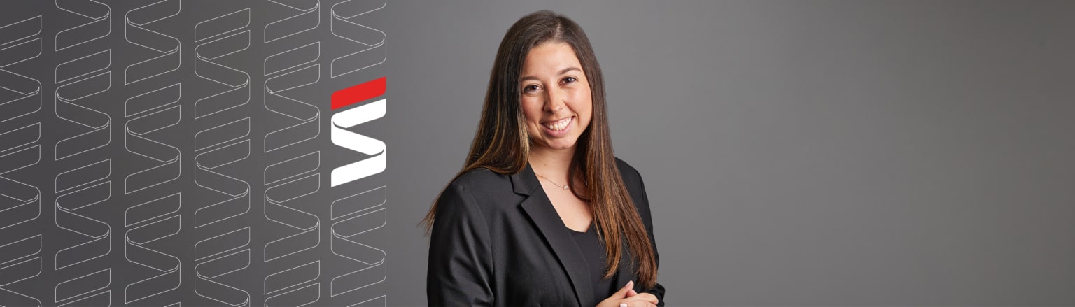 Photo of Isabella Washka, wearing a black shirt and a black jacket. Fraser Stryker logo icon repeating on the left side of the photo.