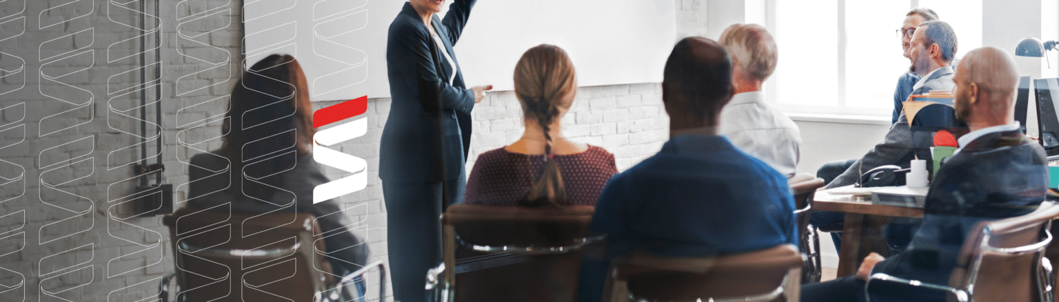 People holding a business meeting, Fraser Stryker logo icon in repetitive pattern on the left of image.