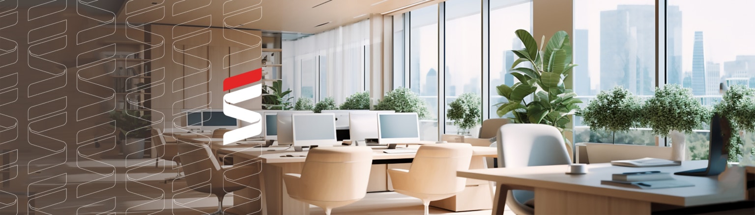 Photo of office with multiple computer work stations. Fraser Stryker logo icon repeating on the left side of the photo.