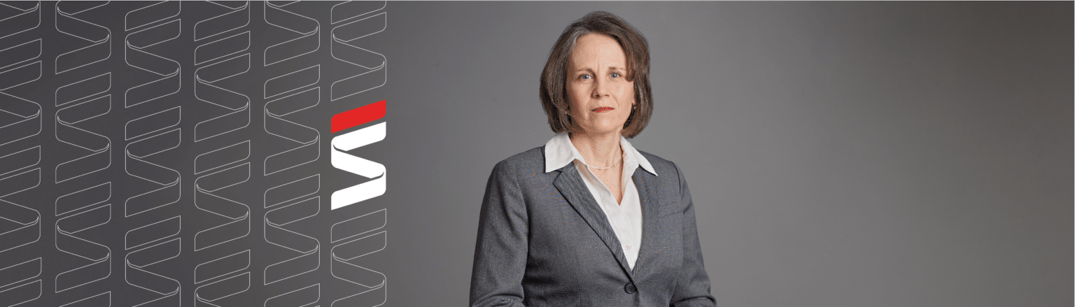 Mary Carnazzo, Fraser Stryker attorney, wearing a grey suit jacket, white shirt, and black pants.