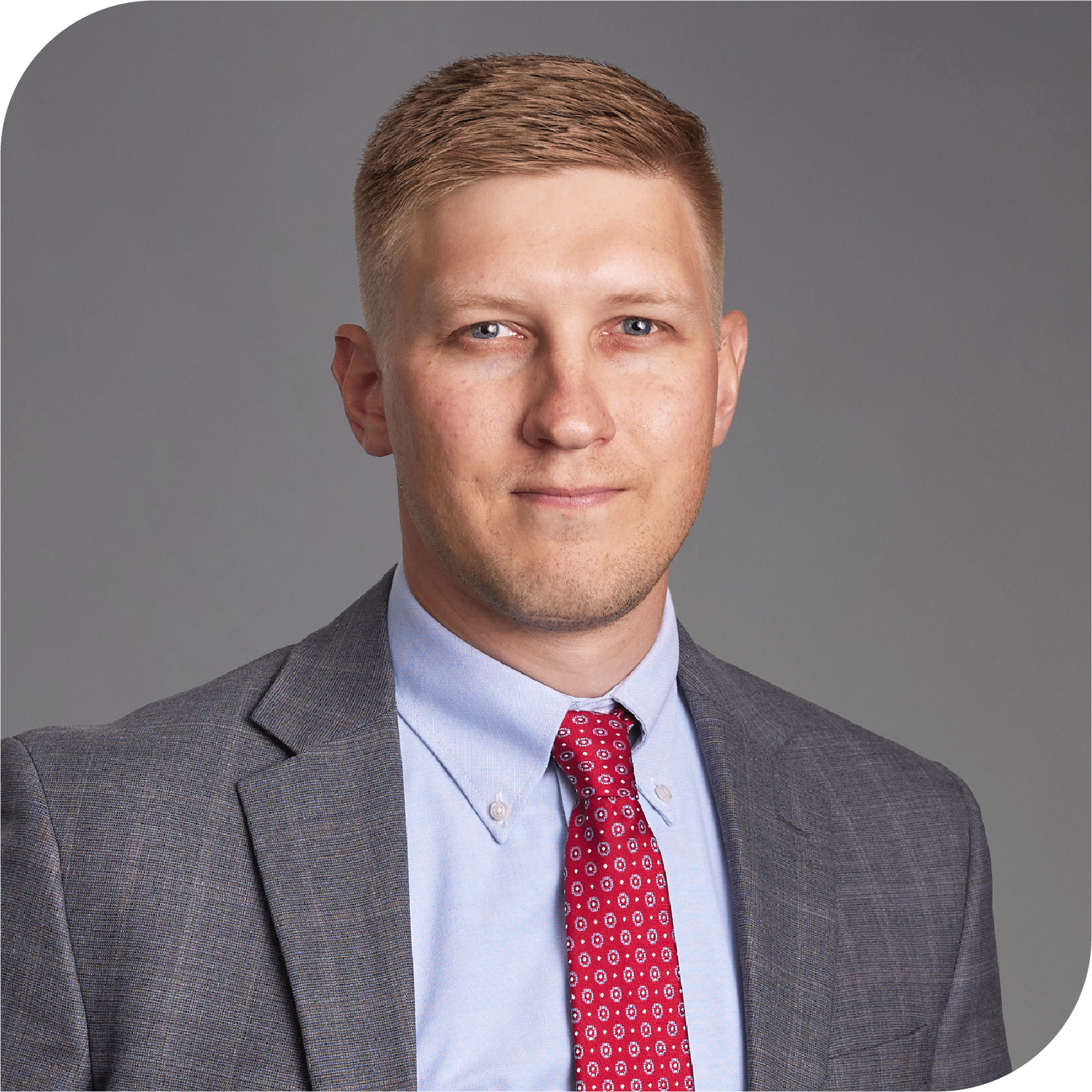 Anthony (Tony) Thies, Fraser Stryker Summer Associate, wearing a dark grey suit jacket and blue shirt with a red tie.