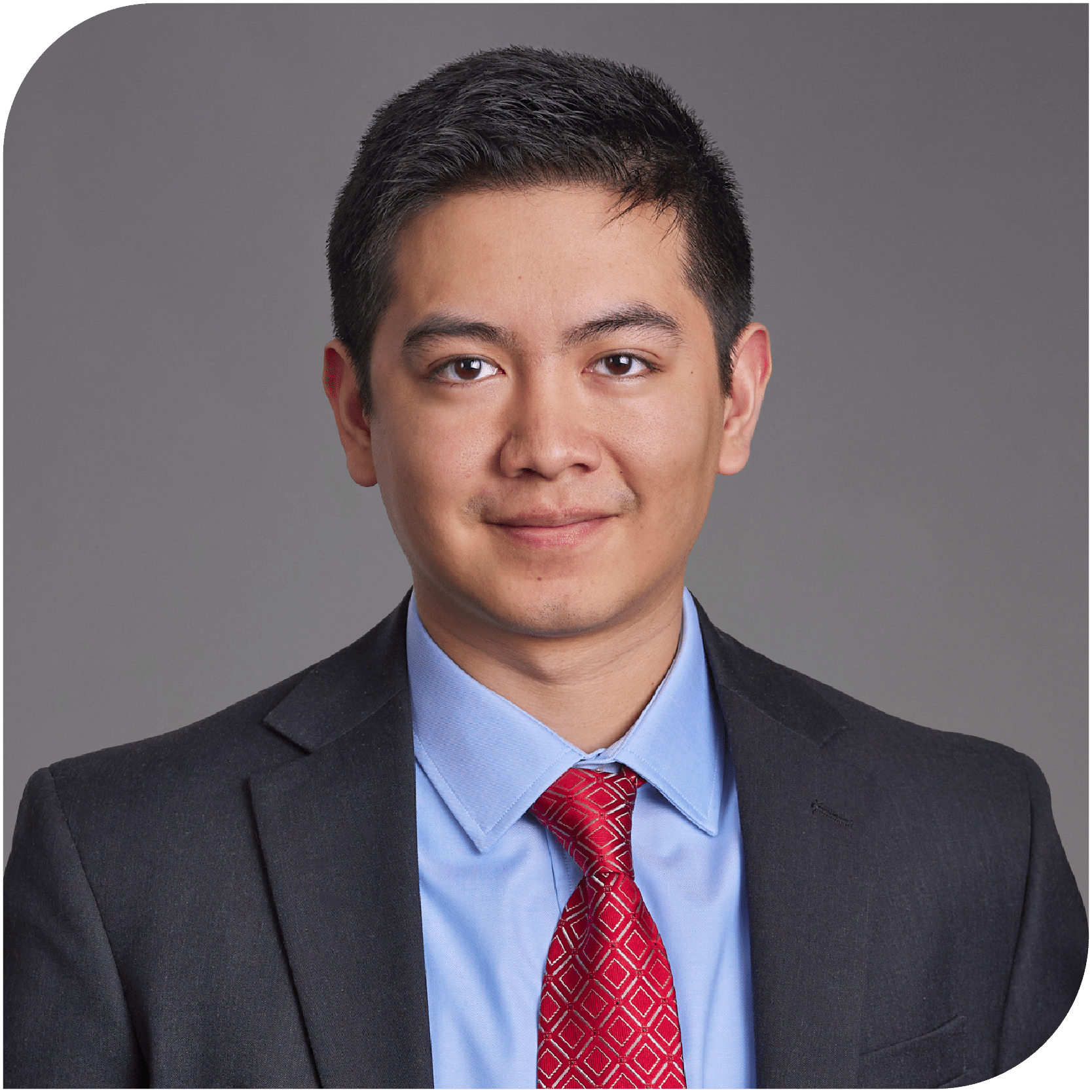 Daniel Ugarte, Fraser Stryker Summer Associate, wearing a dark grey suit jacket with a blue shirt and a red tie.