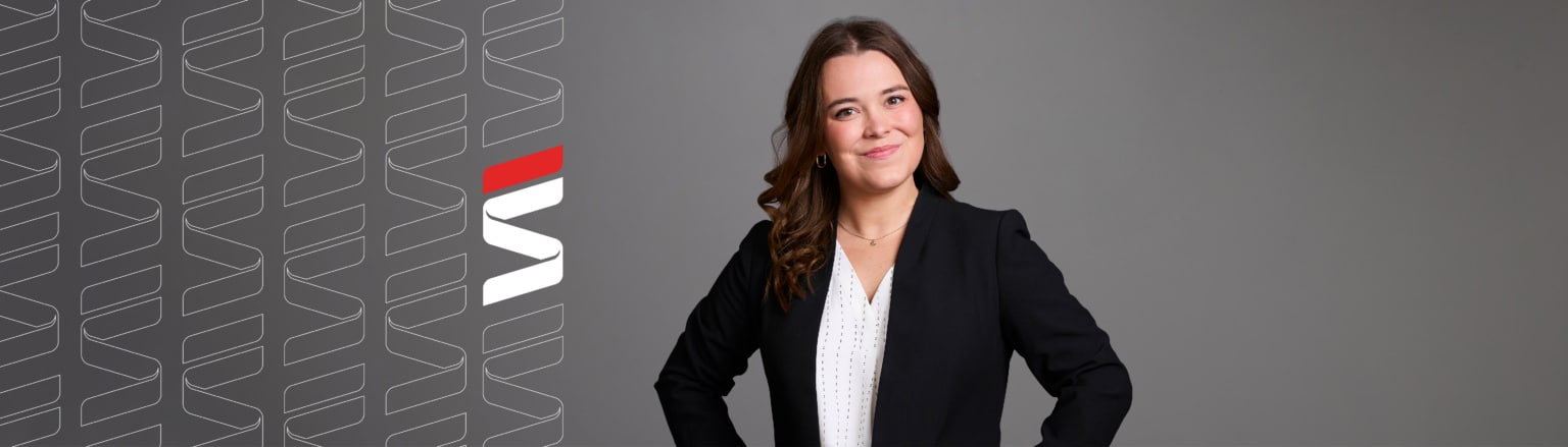 Olivia Stanek, Fraser Stryker attorney, wearing a black suit jacket and a white shirt. Fraser Stryker logo icon repeating on the left side of the photo.