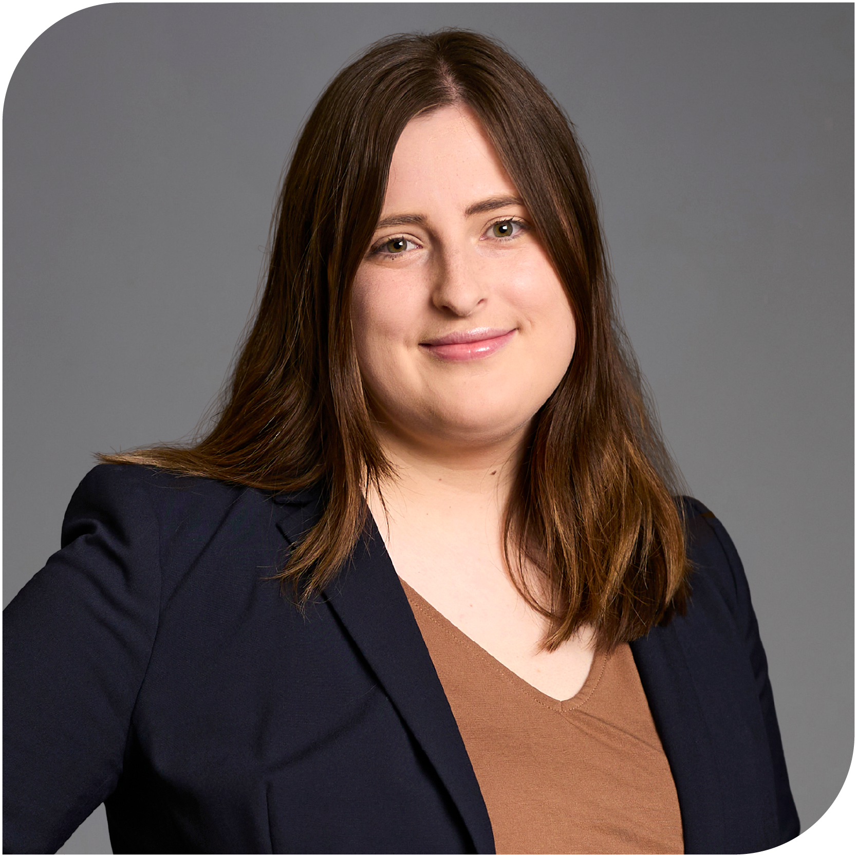 Emma Collins, Fraser Stryker Summer Associate, wearing a black jacket and orange shirt
