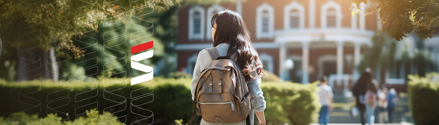 Photo of individual with backpack looking to the left and walking to a building. Other individuals walking to the building in the background and green trees/bushes around. Fraser Stryker logo pattern on the left side.