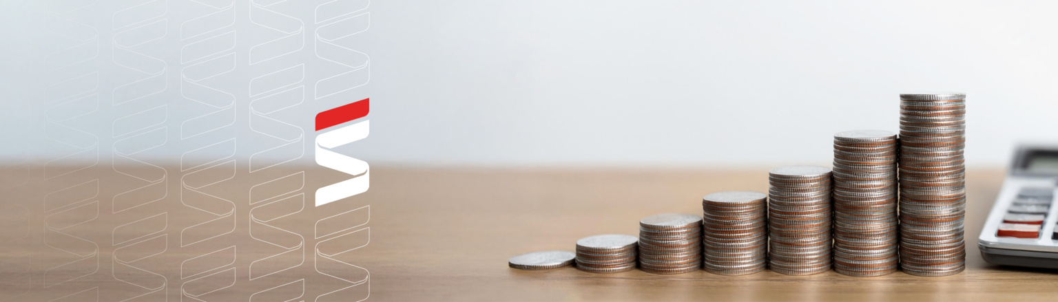 Photo of stacks of coins on wood desk increasing in height from left to right with calculator on the right side of picture. Fraser Stryker logo pattern on the left side.