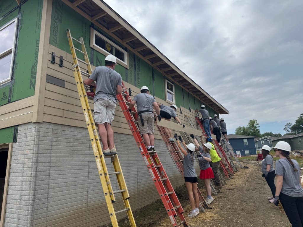 Photo of several FS attorneys and summer associates working on a Habitat for Humanity build site.