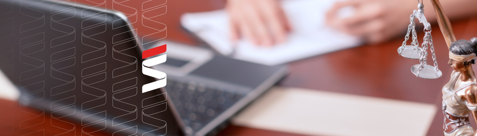 Photo of the hands of one individual at a table signing a paper in background, laptop and lady justice in the foreground. Fraser Stryker logo pattern on the left side.