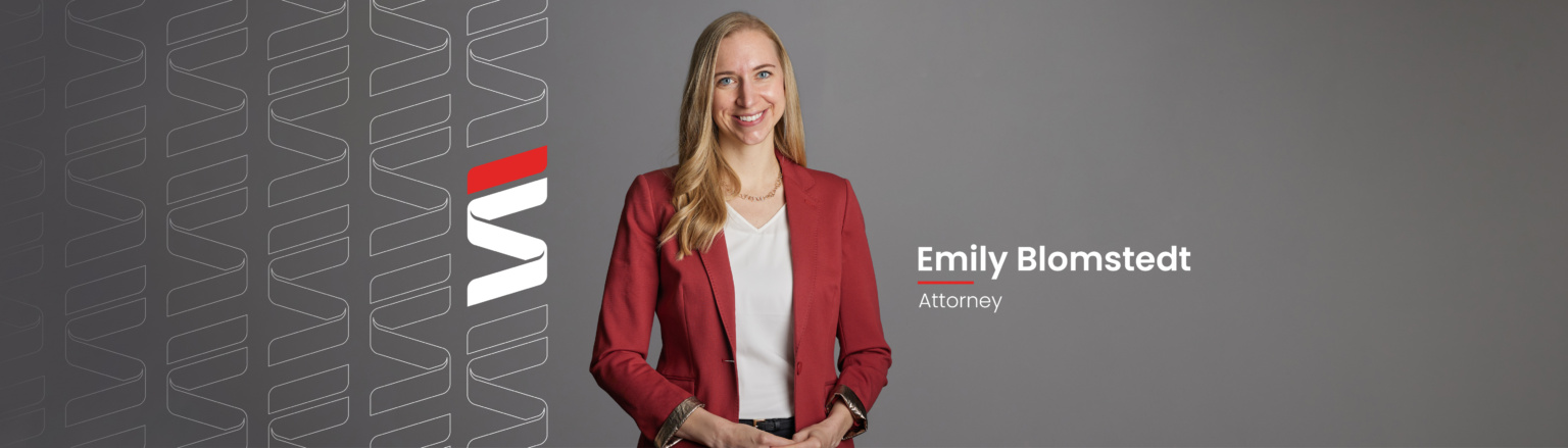 Attorney Emily Blomstedt standing in front of a grey background wearing a red suit jacket and white shirt. Fraser Stryker logo repeating on right side.