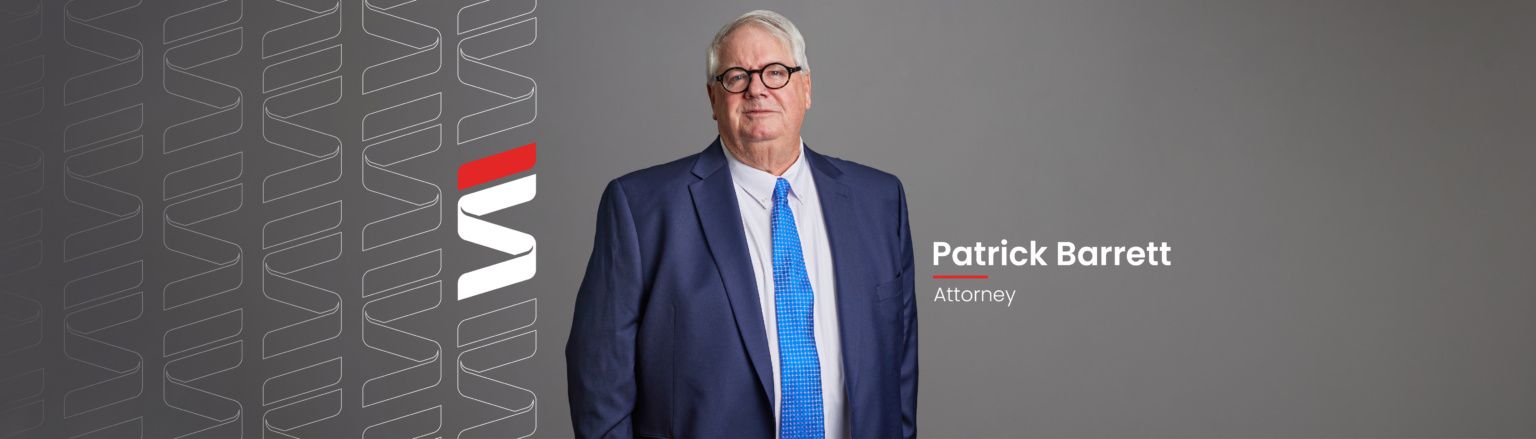 Pat Barrett, Fraser Stryker attorney, wearing a dark blue suit, white shirt and a blue tie. Fraser Stryker logo icon repeating on the left side of the photo.
