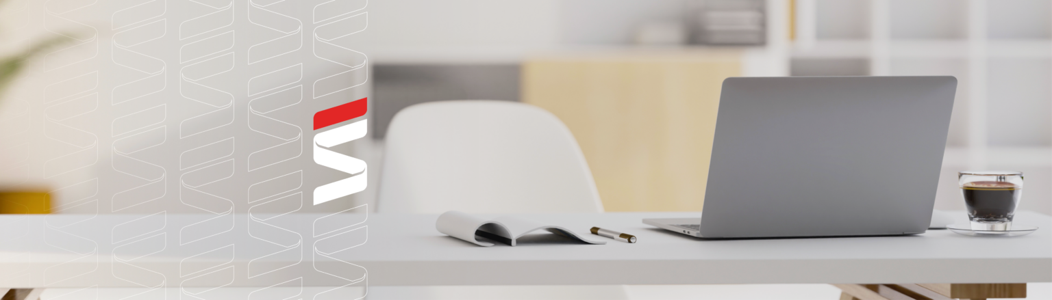 Photo of desk with computer, coffee, pen and notepad. Fraser Stryker logo icon repeating on the left side of the photo.
