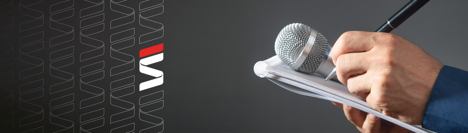 Hand holding mic, notepad and pen. Fraser Stryker logo icons repeating on the left side of the photo.