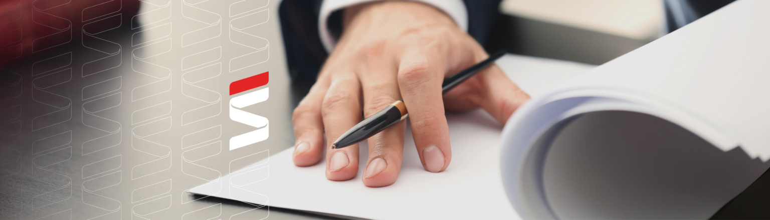A close-up of a person's hand resting on a stack of papers, holding a black pen, with a desk and books in the background. Fraser Stryker logo icon repeating on the left side of the photo.