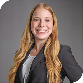 Sadie Lage, Fraser Stryker Summer Associate, wearing a dark grey jacket and white shirt