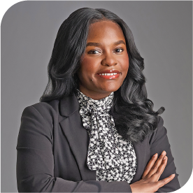 Lois Grace Kanioka, Fraser Stryker Summer Associate, wearing a dark grey jacket and white with grey shirt